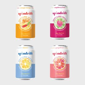 Four Spindrift cans display sparkling water with real fruit images, arranged on a plain background, featuring flavors: orange mango, raspberry lime, lemon, grapefruit.