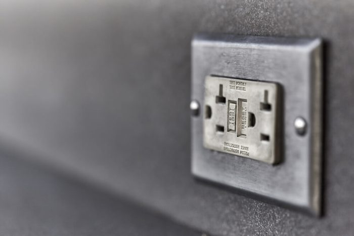 Used Ground fault circuit interrupter electrical wall outlet with shallow depth of field