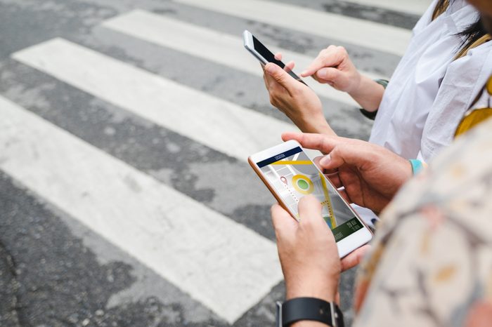 Traveler use map on mobile phone app to search for route location of place with gps on street when travel in city,Technology in lifestyle