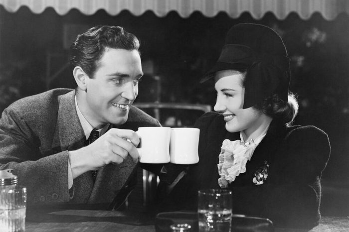 Couple toasting with mugs