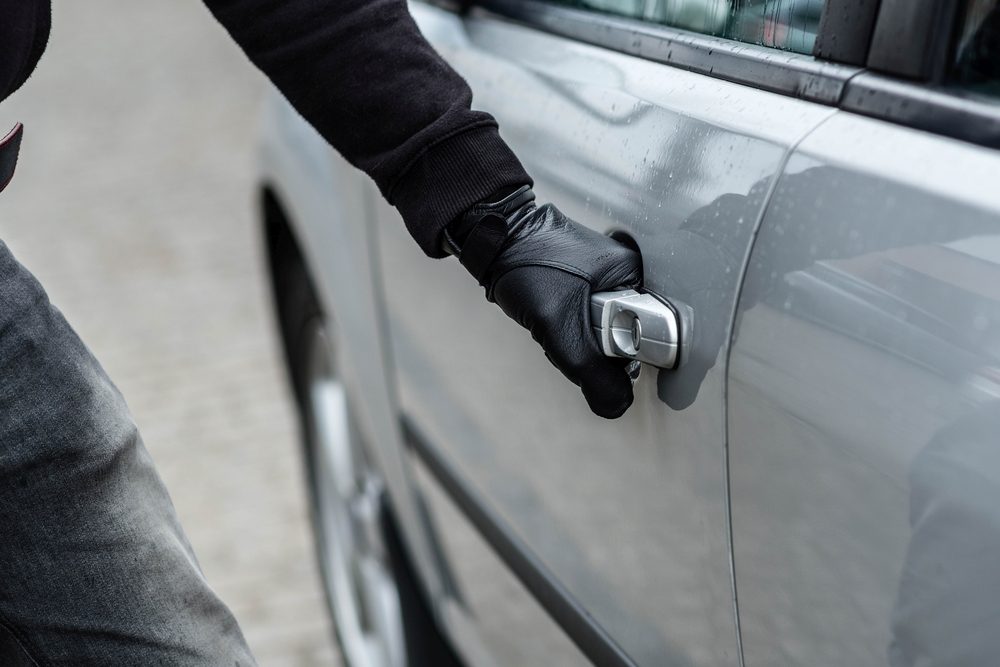 Car thief trying to break into a car