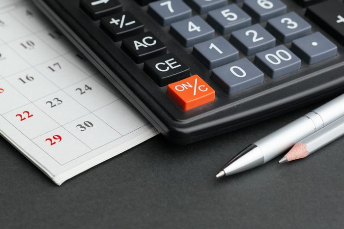 Business still life with calculator on table in office.