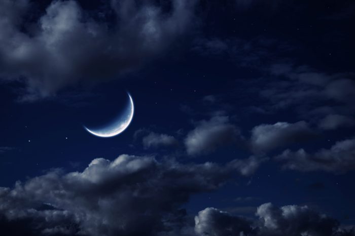 The moon in the night cloudy sky with stars
