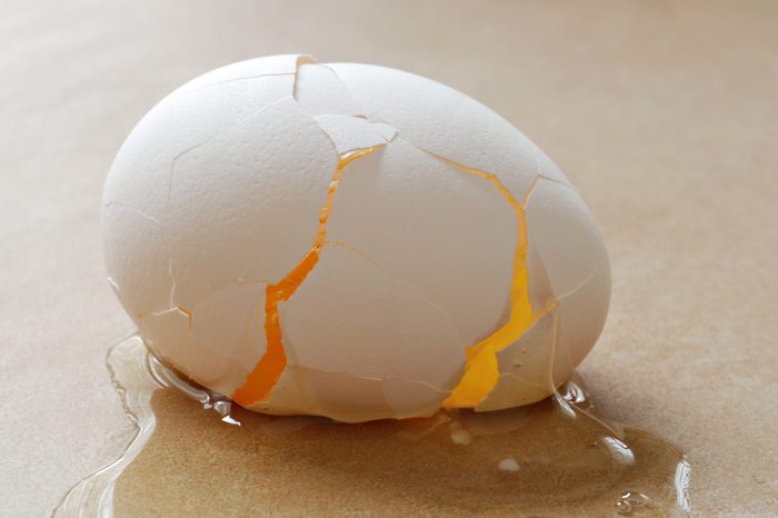 Broken egg on ceramic tile. Abstract macro with backlighting and shallow dof.