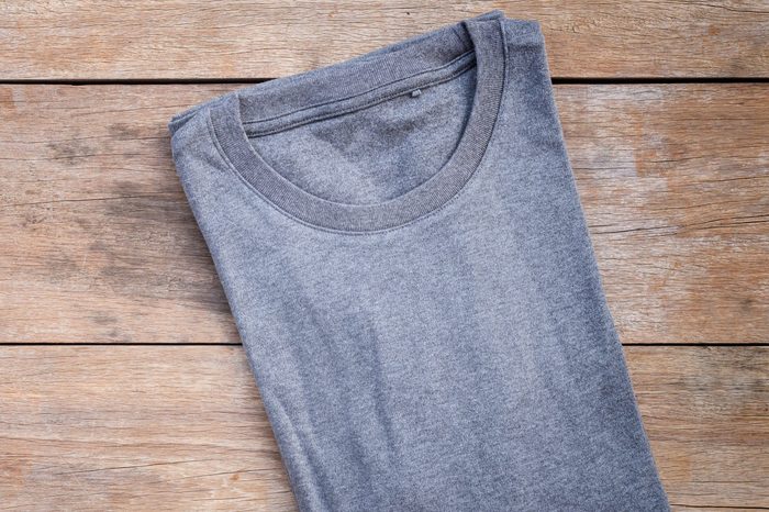 Top view of color T-Shirt on grey wood plank background