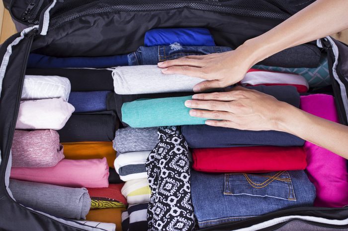 a woman packing a luggage for a new journey 