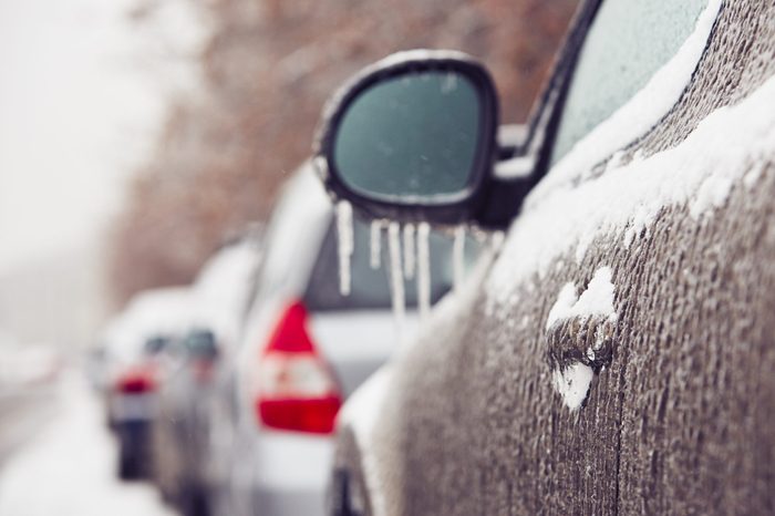 Car on the street covered by icy rain 
