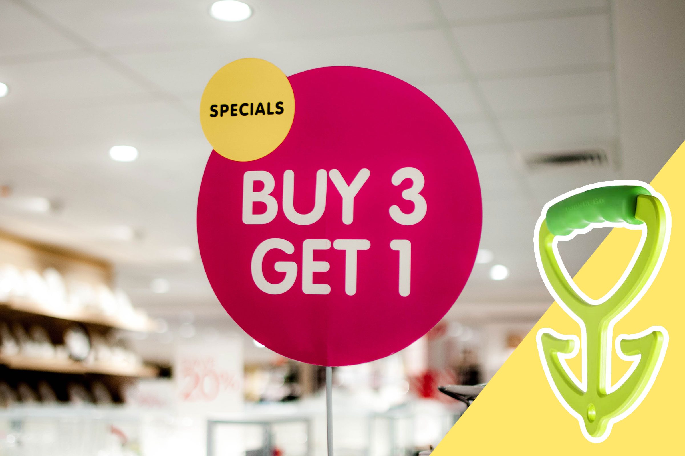 Sign reads "SPECIALS: BUY 3 GET 1," displayed in a store with shelves; a green shopping handle is featured on a yellow background.