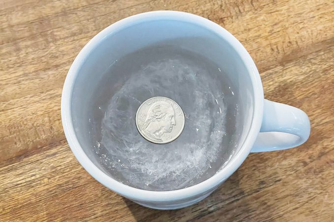 Does Putting a Quarter on a Cup of Frozen Water Before a Major Storm Actually Work?