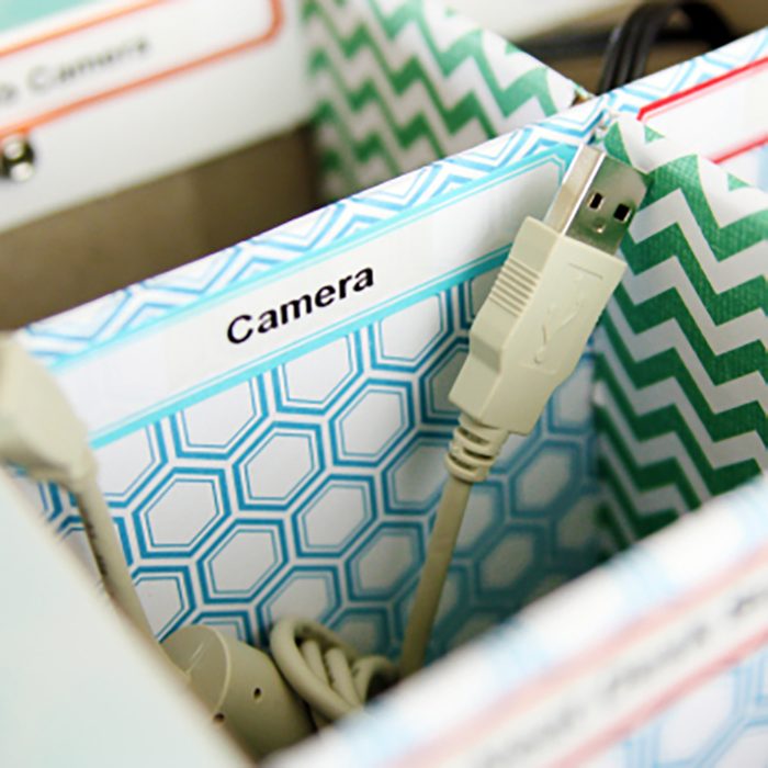 USB cable rests inside patterned box labeled 
