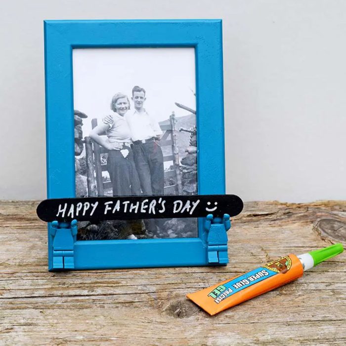Blue frame holds a vintage photo; a stick reads 