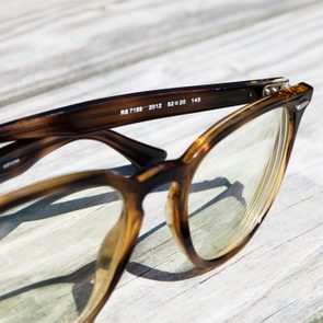 Glasses resting on wooden surface, displaying model numbers 
