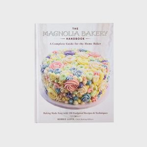 A book cover displays a pastel-decorated cake; the title reads 