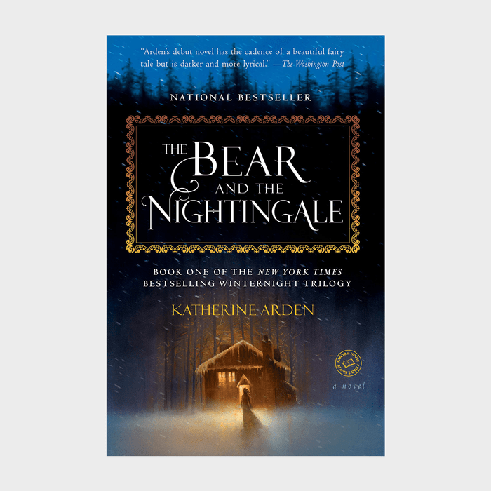 Book cover shows a cabin glowing warmly in snowy woods. Title reads 