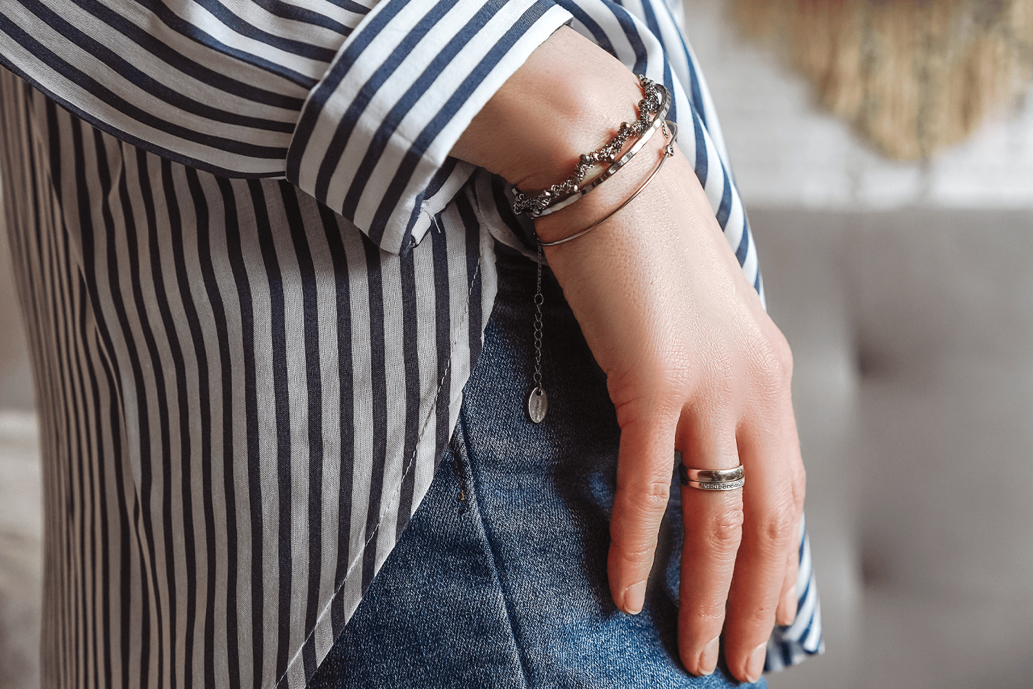 Bracelets and ring on the hand of a young woman close-up, part of body.