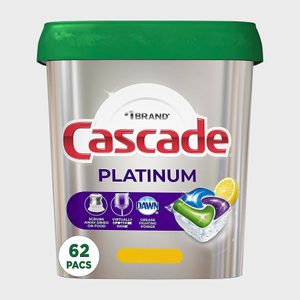 Container holding Cascade Platinum detergent packs displayed with green lid and text emphasizing cleaning features, containing 62 packs, with bright, clean appearance.