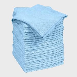 Stacked blue microfiber cloths lie neatly arranged on a white background.