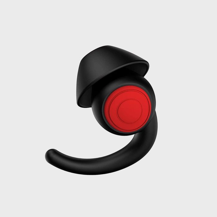 A single black earbud with a red button and flexible hook against a plain gray background.