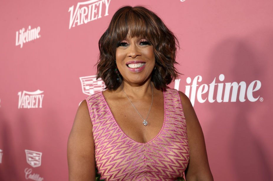 A person smiles, wearing a pink patterned dress, against a pink background with "Variety" and "Lifetime" logos.