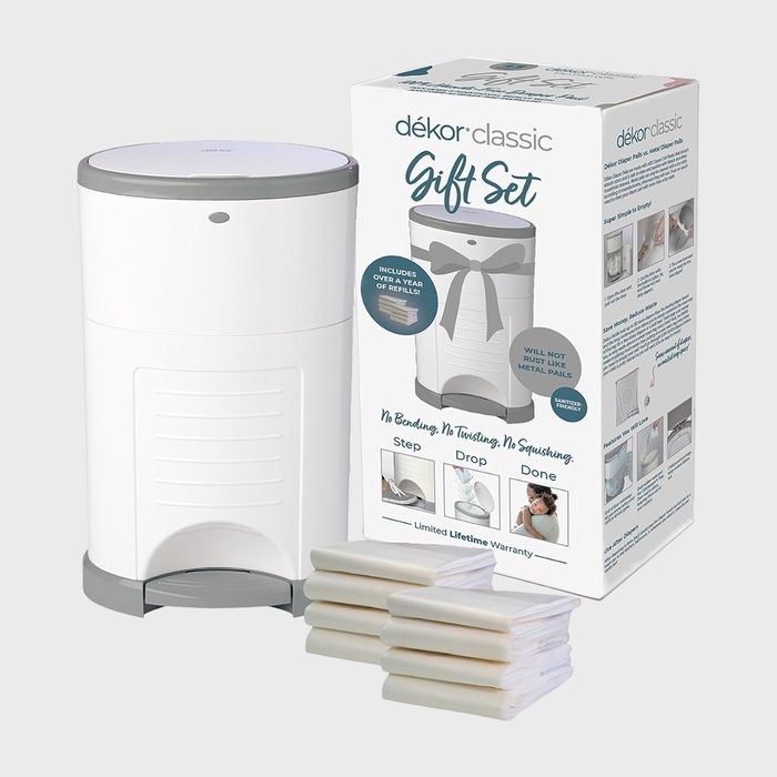 A white diaper pail stands next to its box labeled 