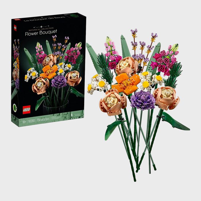 LEGO flower bouquet displayed beside its box, featuring vibrant, detailed blooms against a plain background.