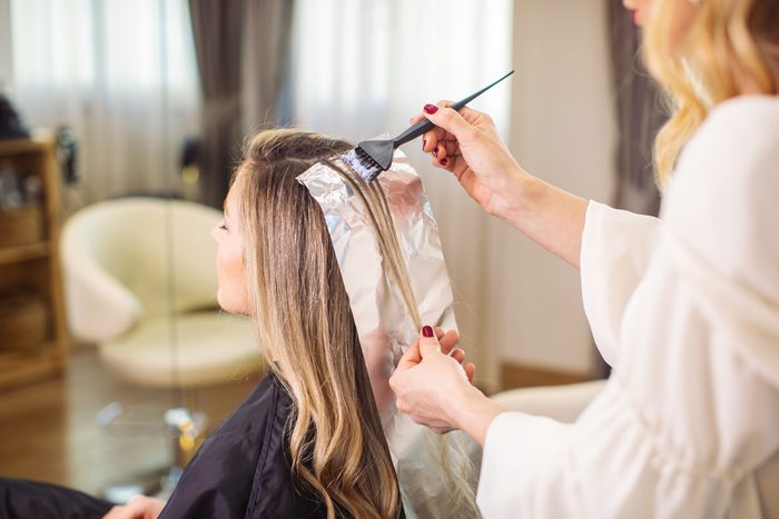 Woman Dyeing Her Hair At The Salon