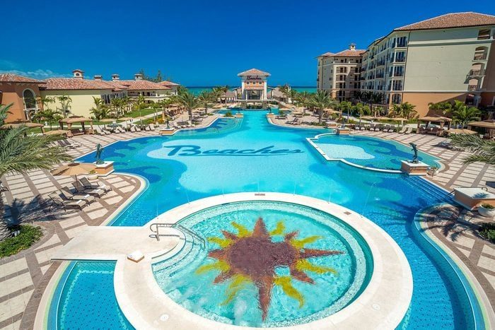 A large swimming pool displays the word 