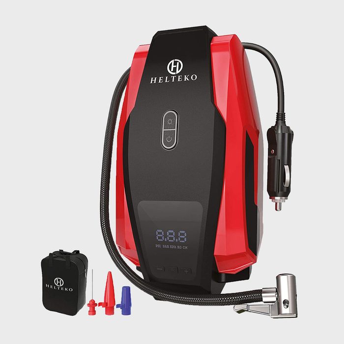 Portable air compressor displays pressure; comes with power cord and various nozzles; situated on a plain background. Text reads 