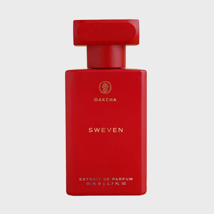 Red perfume bottle stands upright, displaying 