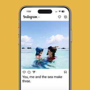 Two people swim in clear ocean water, wearing hats, under a bright blue sky. Caption: 