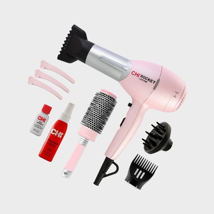 Hairdryer in pink set with accessories including brushes, clips, and CHI hair products, displayed on a plain background.
