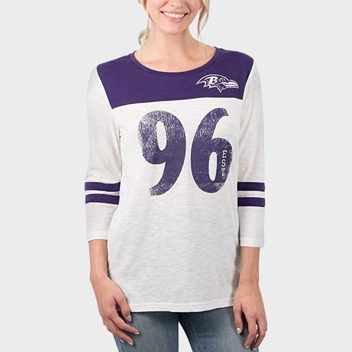 Person wears a purple and white shirt with 