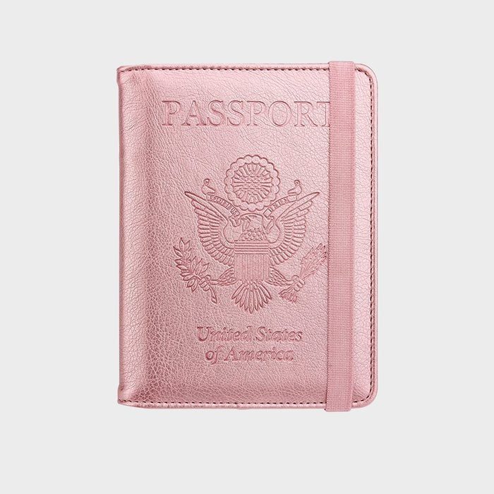 Pink passport cover embossed with the U.S. emblem, secured by an elastic band, set against a plain background.