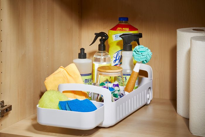 Cleaning supplies organized in a rolling organizer to help easily access deep shelves or cabinets