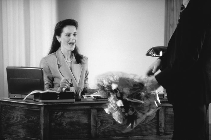 woman looking at flowers