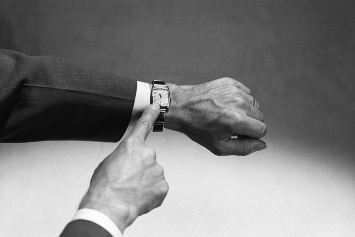 pointing to wristwatch with hand