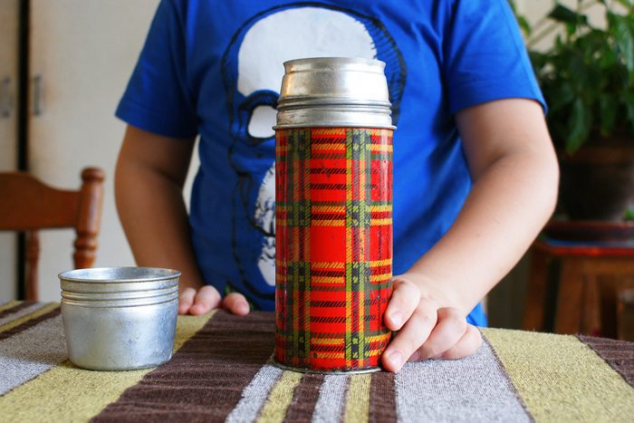 child holding a thermos