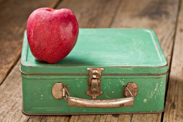 metal lunchbox with apple on top