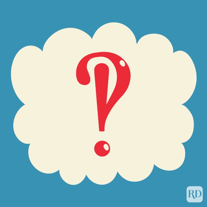 Interrobang in the color red on a beige cloud on blue background.