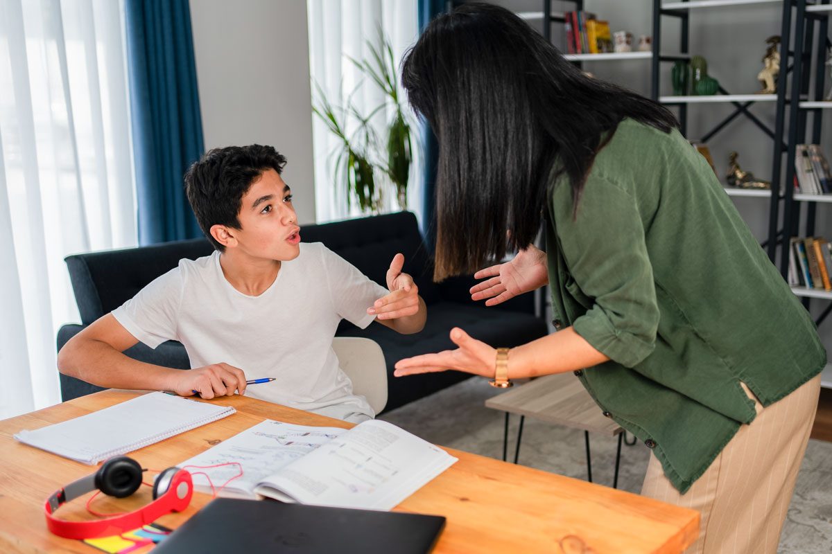 Mother And Her Teenage Son Arguing At Home