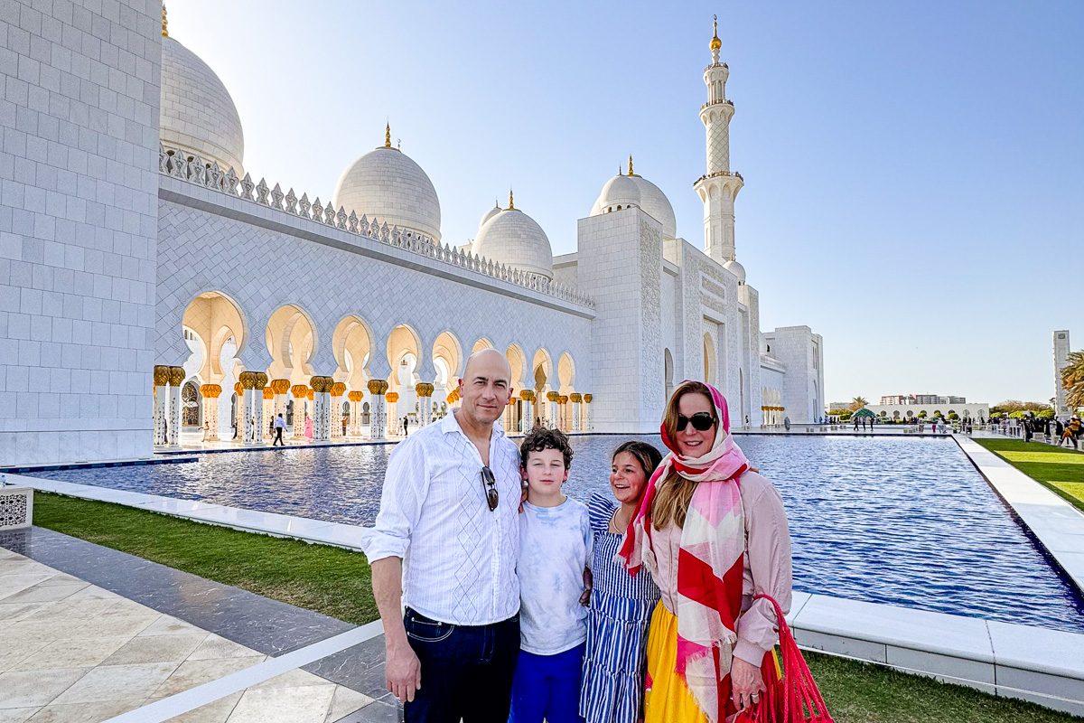 family posing in front of Sheikh Zayed Grand Mosque